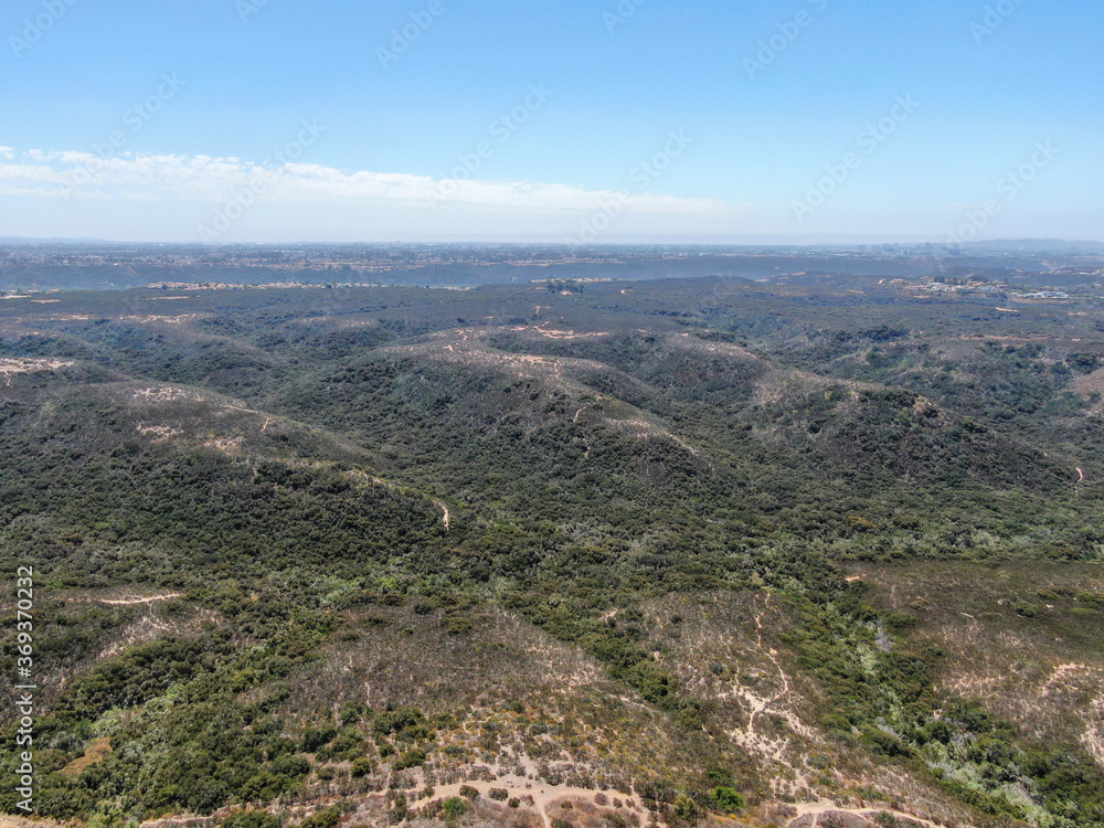 Aerial view of Los Penasquitos Canyon Preserve during summer season. Urban park with trails and river in San Diego, California. USA