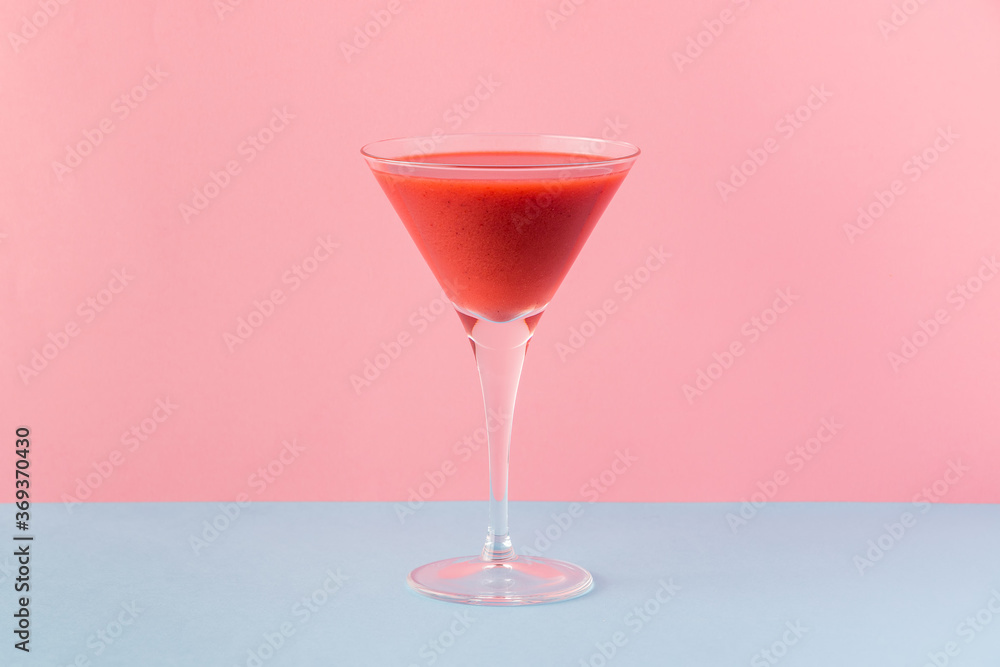 Strawberry smoothie cup on a pink and light blue background Strawberry smoothie cup on a pink and light blue background