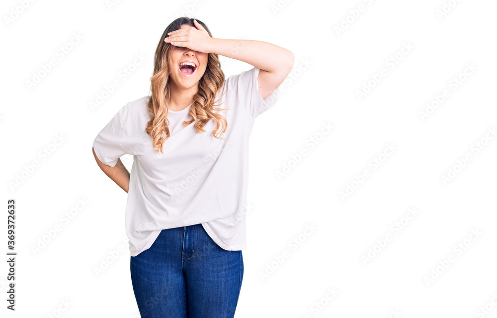 Young caucasian woman wearing casual clothes smiling and laughing with hand on face covering eyes for surprise. blind concept. Young caucasian woman wearing casual clothes smiling and laughing with hand on face covering eyes for surprise. blind concept.