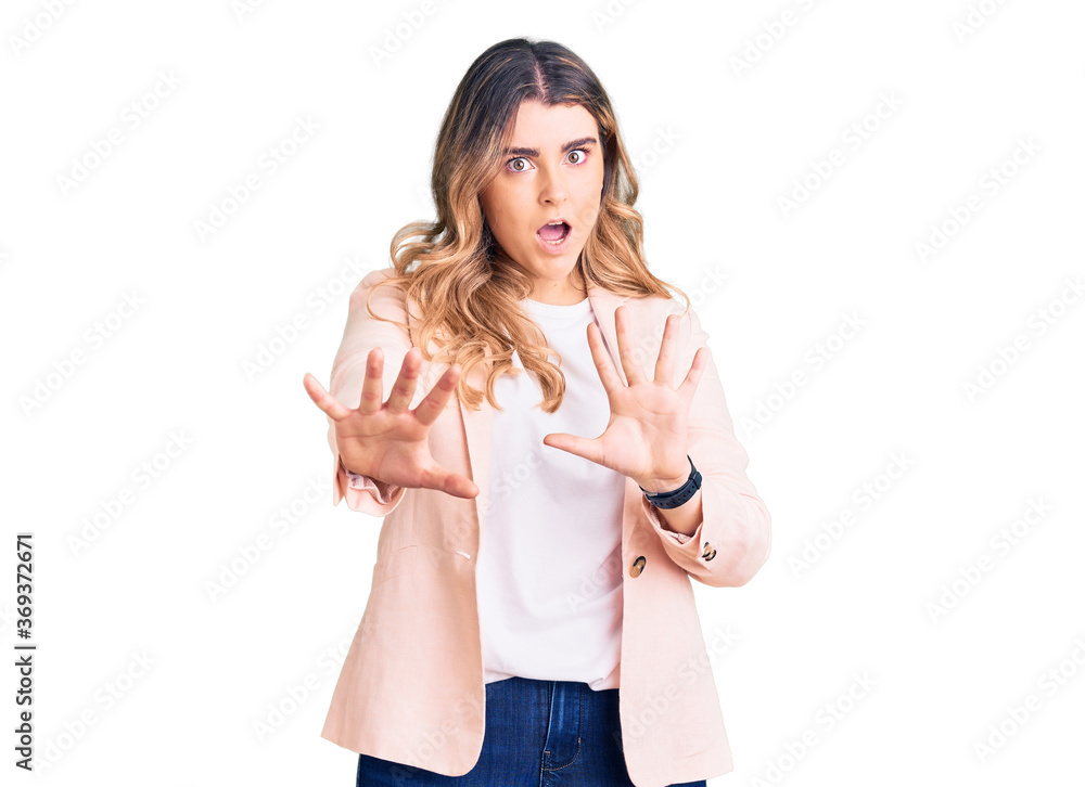 Young caucasian woman wearing business clothes doing stop gesture with hands palms, angry and frustration expression Young caucasian woman wearing business clothes doing stop gesture with hands palms, angry and frustration expression
