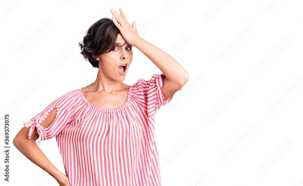 Beautiful young woman with short hair wearing casual summer clothes surprised with hand on head for mistake, remember error. forgot, bad memory concept. Beautiful young woman with short hair wearing casual summer clothes surprised with hand on head for mistake, remember error. forgot, bad memory concept.