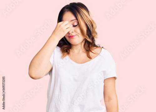 Young beautiful caucasian woman wearing casual white tshirt tired rubbing nose and eyes feeling fatigue and headache. stress and frustration concept.