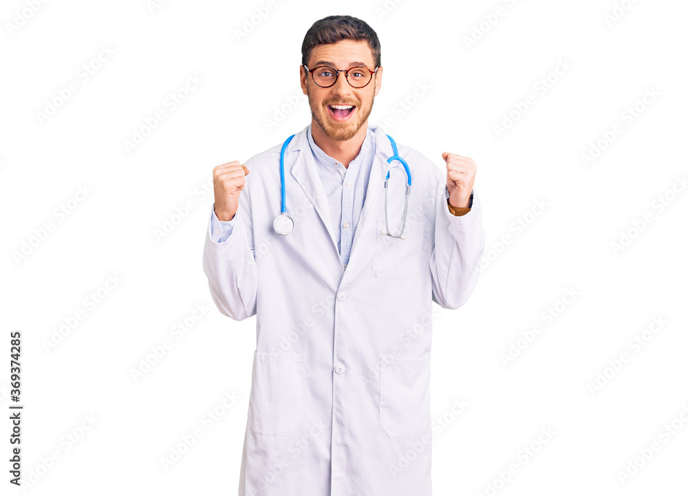 Handsome young man with bear wearing doctor uniform celebrating surprised and amazed for success with arms raised and open eyes. winner concept.