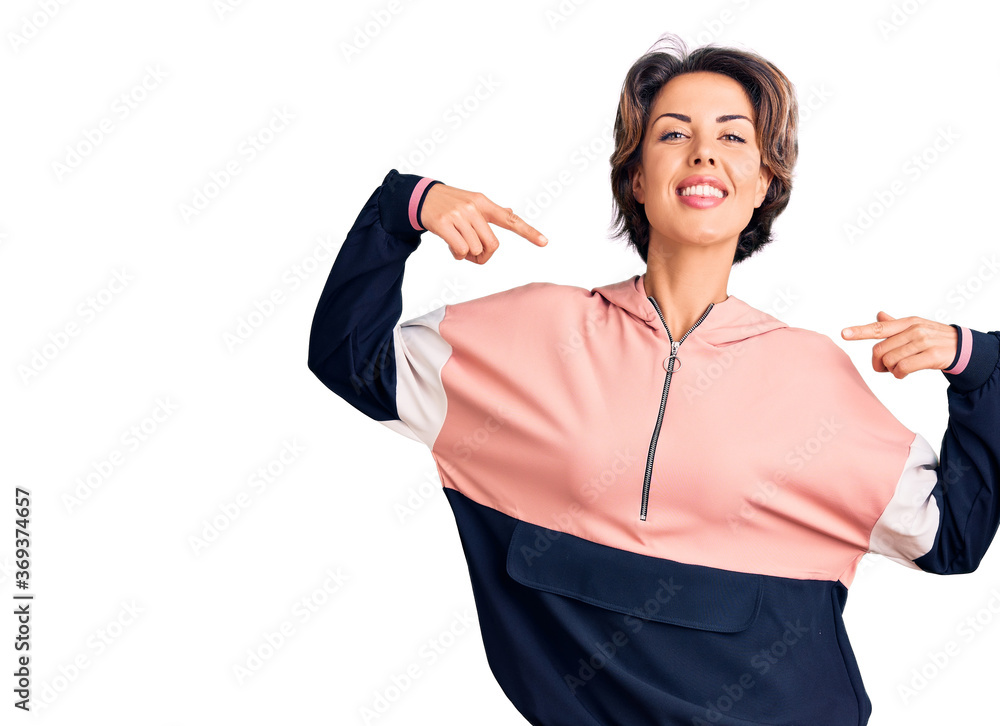 Young beautiful woman wearing sportswear looking confident with smile on face, pointing oneself with fingers proud and happy. Young beautiful woman wearing sportswear looking confident with smile on face, pointing oneself with fingers proud and happy.