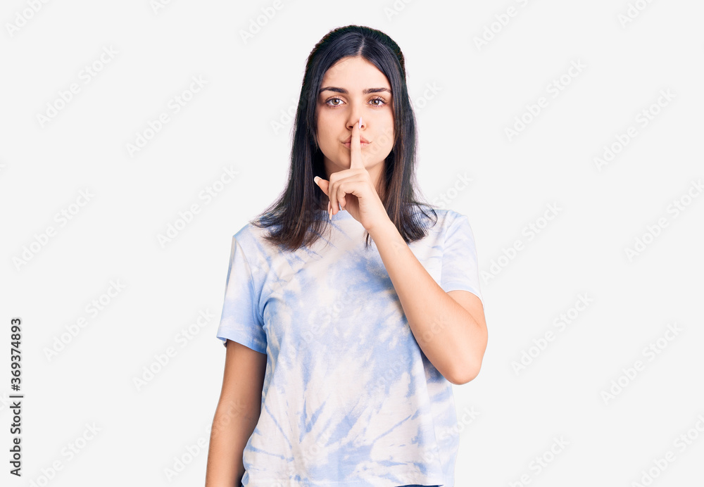 Young beautiful girl wearing casual t shirt asking to be quiet with finger on lips. silence and secret concept. Young beautiful girl wearing casual t shirt asking to be quiet with finger on lips. silence and secret concept.