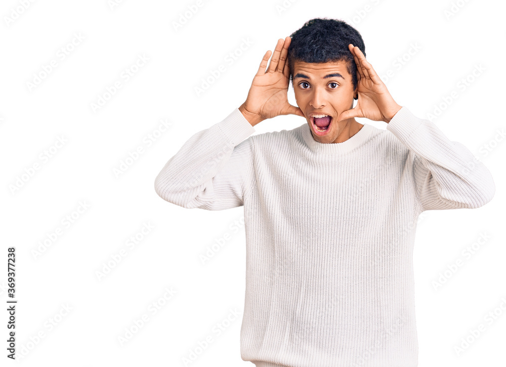 Young african amercian man wearing casual clothes smiling cheerful playing peek a boo with hands showing face. surprised and exited Young african amercian man wearing casual clothes smiling cheerful playing peek a boo with hands showing face. surprised and exited