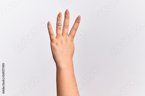Hand of caucasian young woman counting number 4 showing four fingers © Krakenimages.com