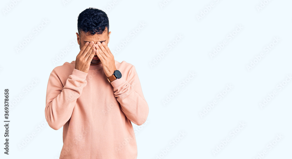 Young hispanic man wearing casual clothes rubbing eyes for fatigue and headache, sleepy and tired expression. vision problem