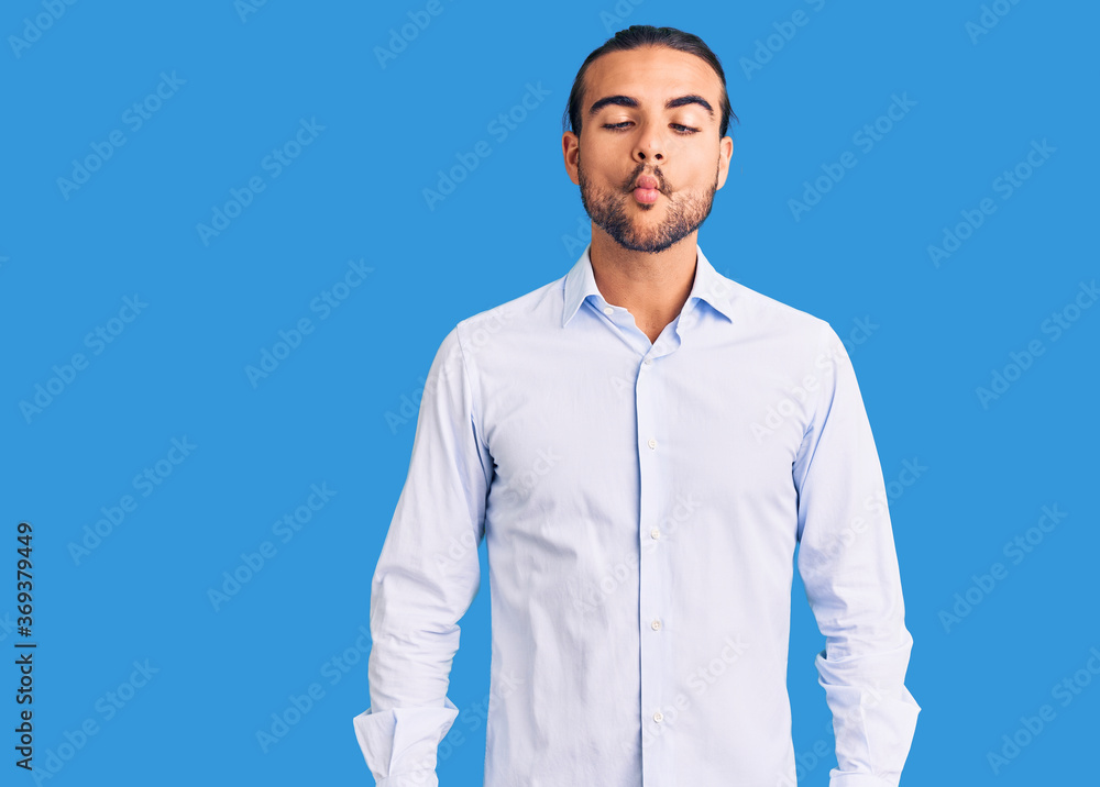 Young handsome man wearing business clothes making fish face with lips, crazy and comical gesture. funny expression. Young handsome man wearing business clothes making fish face with lips, crazy and comical gesture. funny expression.