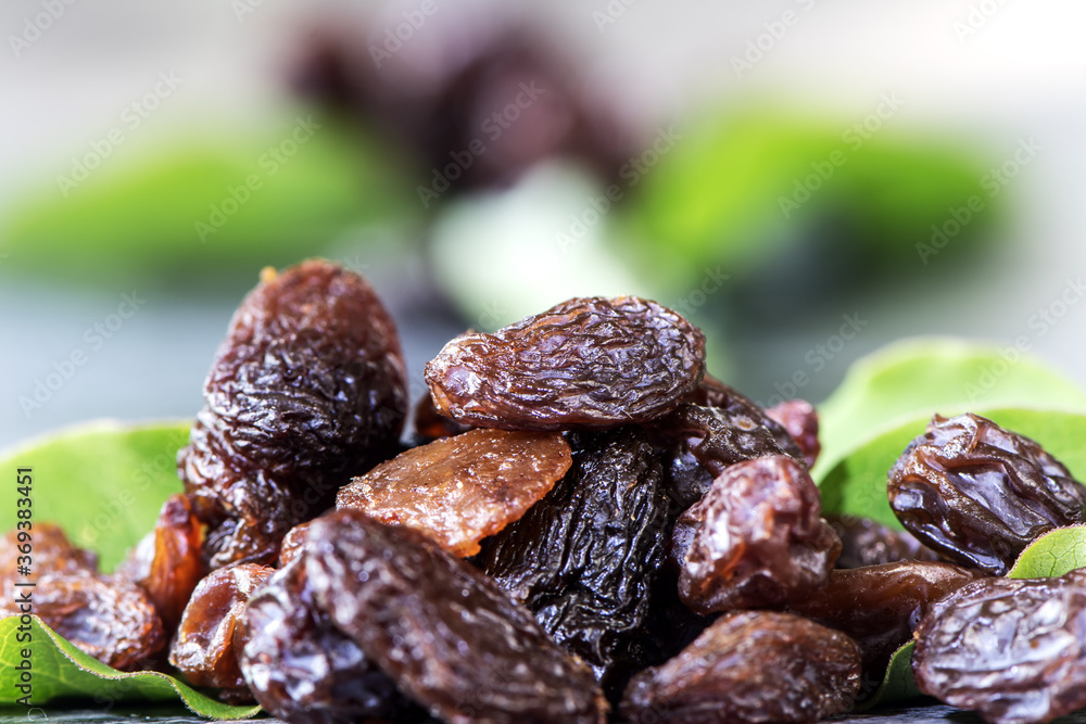 Raisins with reflection. extreme closeup showing detailed texture on blurred background