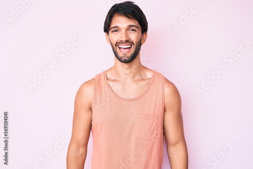 Handsome hispanic man wearing casual clothes with a happy and cool smile on face. lucky person.