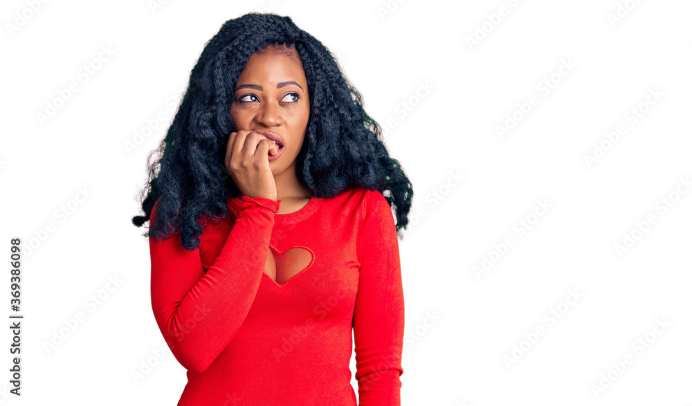 Beautiful african american woman wearing casual clothes looking stressed and nervous with hands on mouth biting nails. anxiety problem. Beautiful african american woman wearing casual clothes looking stressed and nervous with hands on mouth biting nails. anxiety problem.