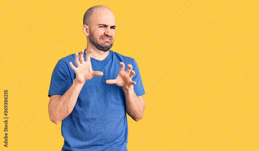 Young handsome man wearing casual t shirt disgusted expression, displeased and fearful doing disgust face because aversion reaction. with hands raised Young handsome man wearing casual t shirt disgusted expression, displeased and fearful doing disgust face because aversion reaction. with hands raised