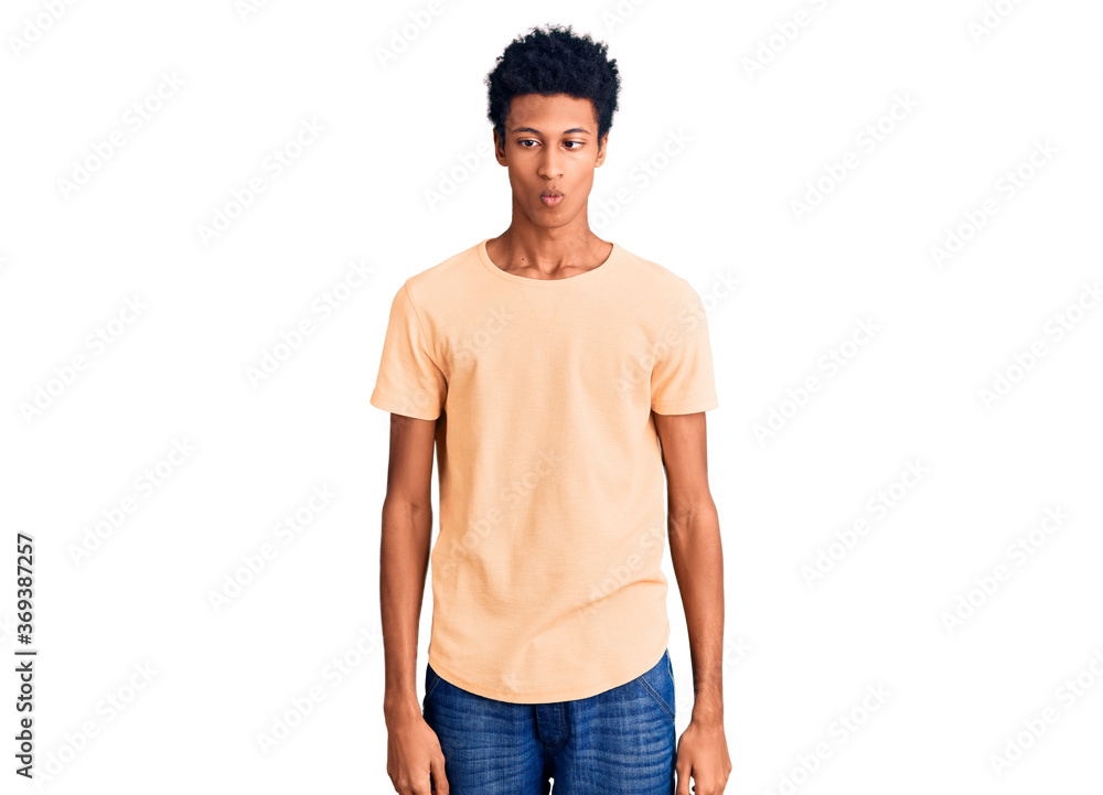 Young african american man wearing casual clothes making fish face with lips, crazy and comical gesture. funny expression. Young african american man wearing casual clothes making fish face with lips, crazy and comical gesture. funny expression.