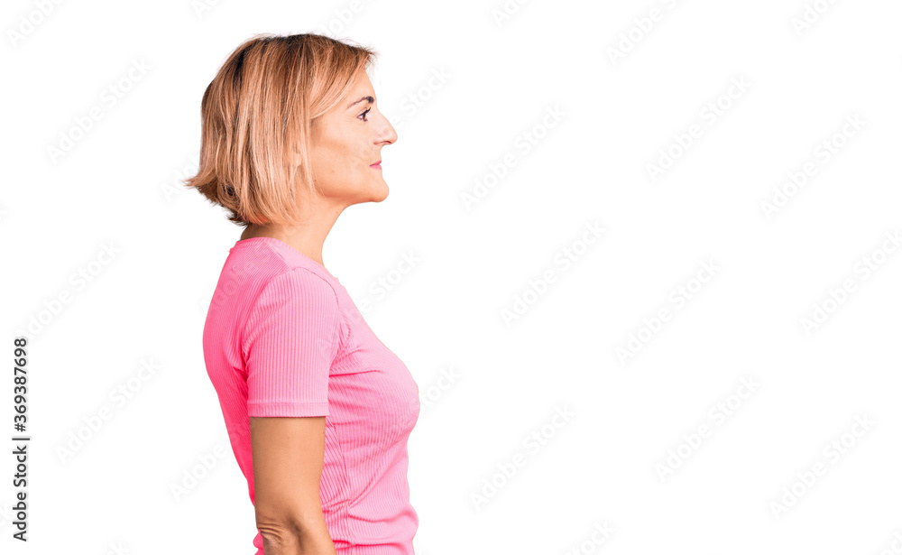 Young blonde woman wearing sportswear looking to side, relax profile pose with natural face and confident smile. Young blonde woman wearing sportswear looking to side, relax profile pose with natural face and confident smile.
