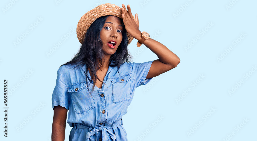 Young indian girl wearing summer hat surprised with hand on head for mistake, remember error. forgot, bad memory concept. Young indian girl wearing summer hat surprised with hand on head for mistake, remember error. forgot, bad memory concept.