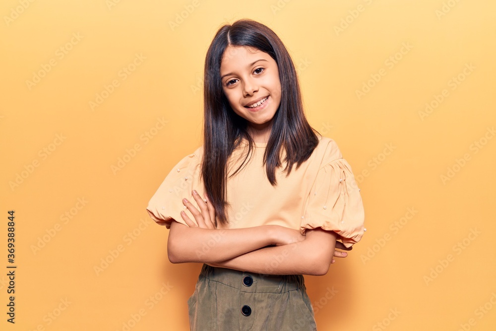 Beautiful child girl wearing casual clothes happy face smiling with crossed arms looking at the camera. positive person. Beautiful child girl wearing casual clothes happy face smiling with crossed arms looking at the camera. positive person.