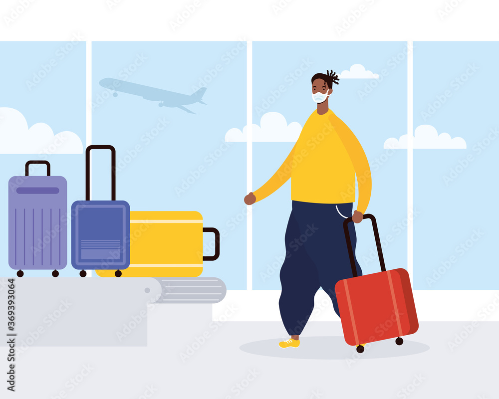 afro young man wearing medical mask with suitcases in transport band afro young man wearing medical mask with suitcases in transport band