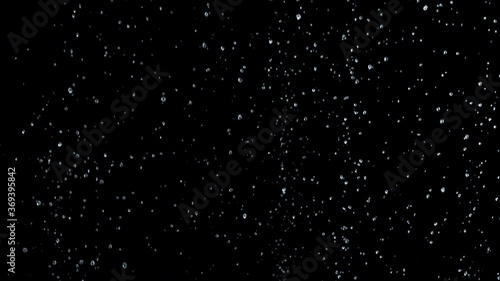 Close-up of bubbles air in under water floating up to water surface. 
The camera moves through bubbles. Isolated on black background. Alpha channel included in the end of the clip.
