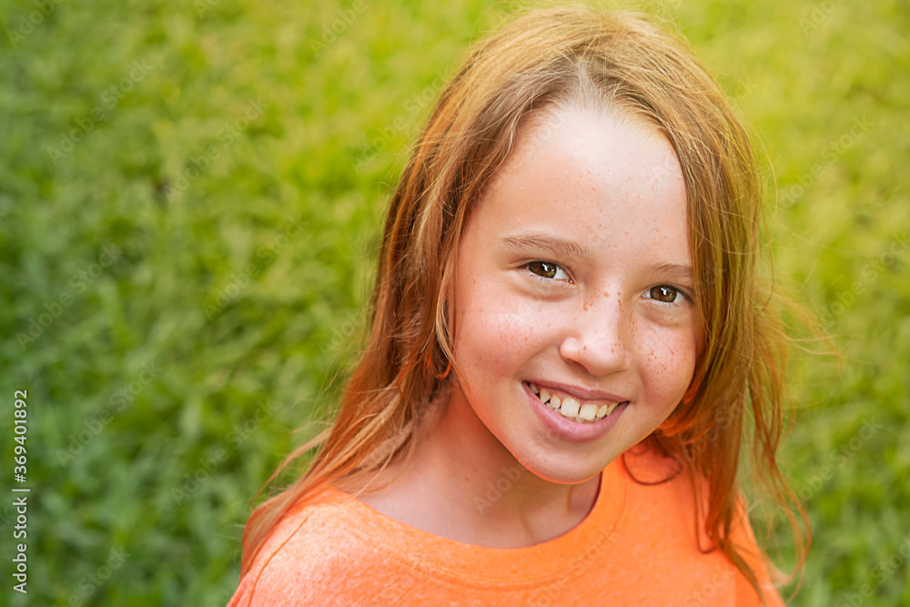 portrait of a child in the park against a background of grass portrait of a child in the park against a background of grass