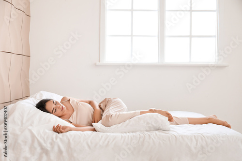Young woman sleeping in bed...