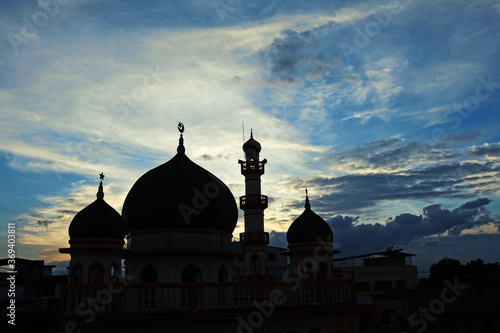 Silhouette of mosque at sunset
