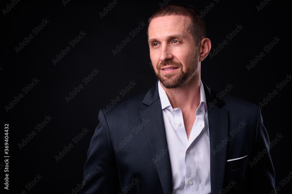 Portrait of happy handsome bearded businessman in suit Portrait of happy handsome bearded businessman in suit