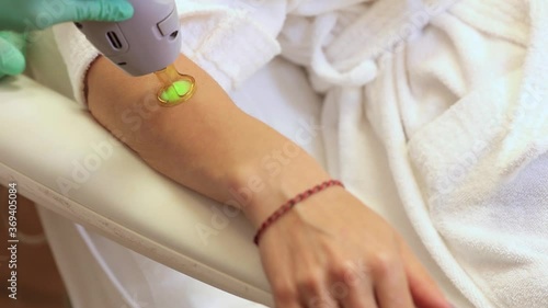 Wallpaper Mural Laser hair removal with a modern device on the arm and leg of a young and beautiful woman. Hair removal by laser surgery Torontodigital.ca