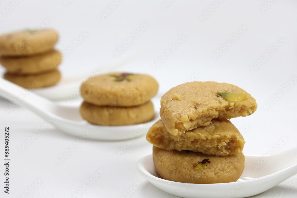Milk peda is a traditional Indian sweet made from milk or khoya and garnished with pistachio to celebrate festivals like Diwali.
