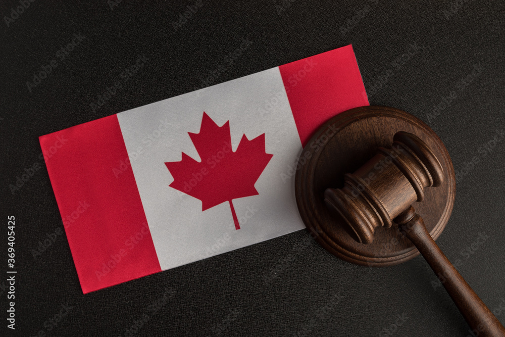 Judge Gavel and flag of Canada. Violation of human rights. Law and justice