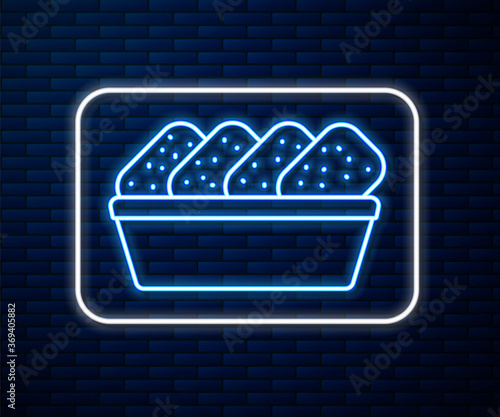 Glowing neon line Chicken nuggets in box icon isolated on brick wall background. Vector Illustration.