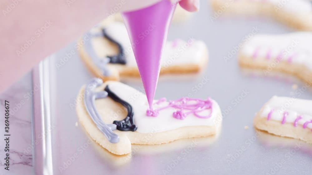Icing figure skate shaped sugar cookies with royal icing. Icing figure skate shaped sugar cookies with royal icing.