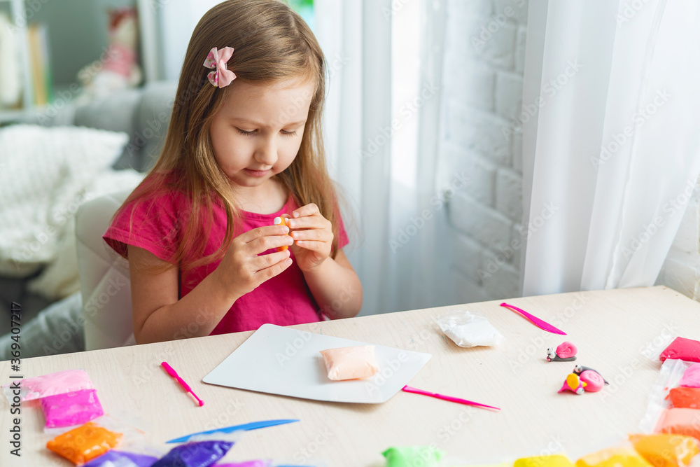 Charming cute little baby girl with soft colorful clay. Charming cute little baby girl with soft colorful clay.