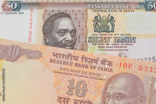 Wallpaper Mural A macro image of a orange ten rupee bill from India paired up with a colorful fifty shilling bank note from Kenya.  Shot close up in macro. Torontodigital.ca