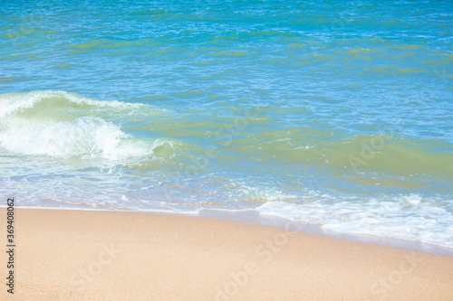 The beach and sea surface with Deep Blue sea clear sky clouds. Landscape with Ocean small waves water reflection copy space for text. Illustration for tourism, website or ad. Andaman sea, Thailand.