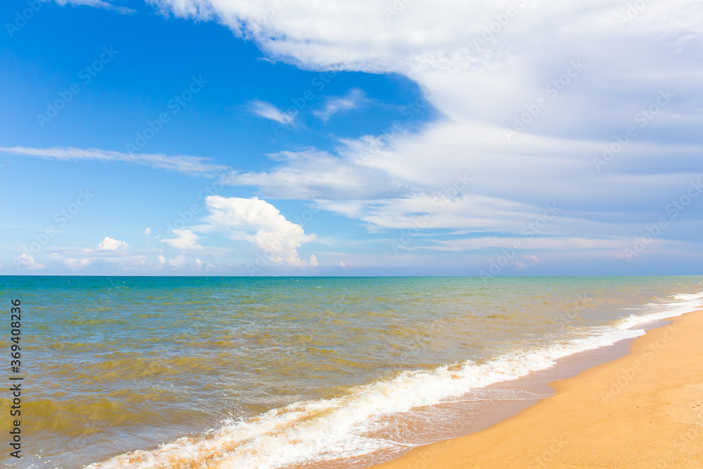 The beach and sea surface with Deep Blue sea clear sky clouds. Landscape with Ocean small waves water reflection copy space for text. Illustration for tourism, website or ad. Andaman sea, Thailand.