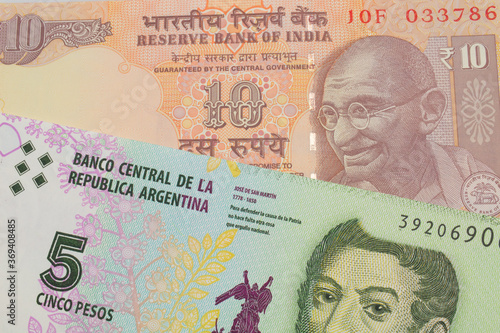 Wallpaper Mural A macro image of a orange ten rupee bill from India paired up with a colorful five peso note from Argentina.  Shot close up in macro. Torontodigital.ca