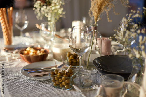 eating  holiday and celebration concept - dinner party table serving at home