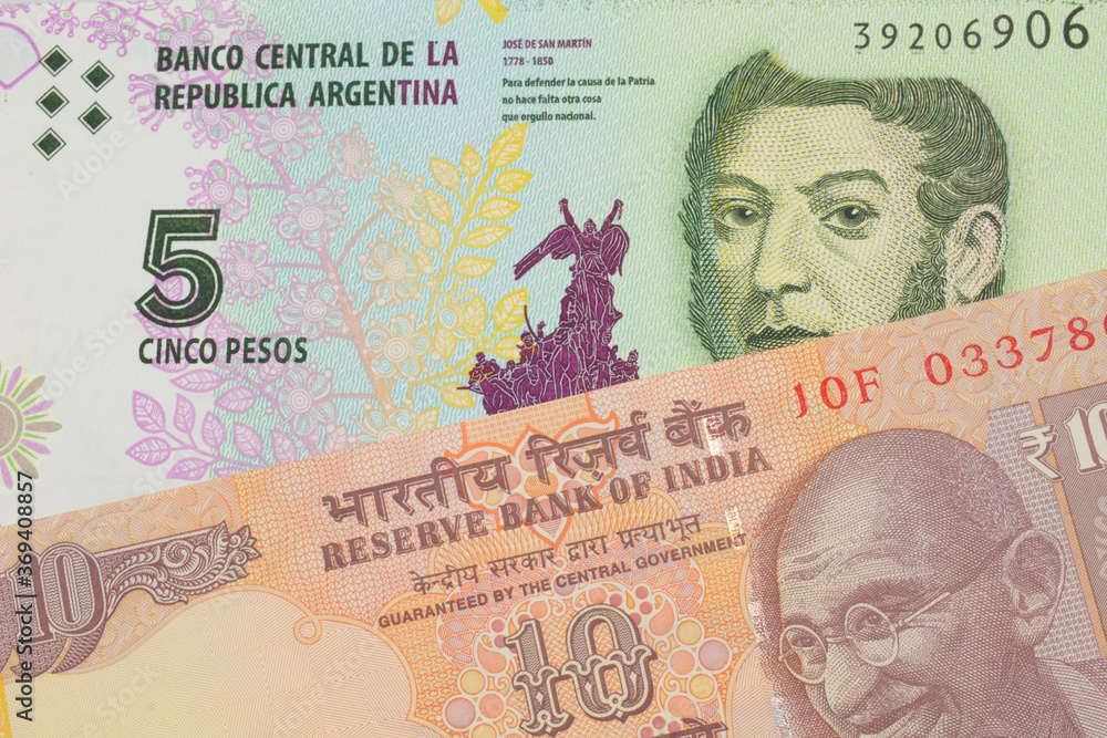 A macro image of a orange ten rupee bill from India paired up with a colorful five peso note from Argentina.  Shot close up in macro.