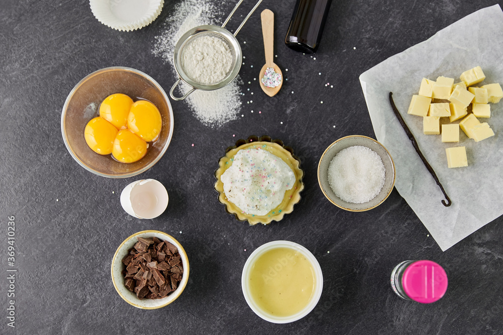 food, culinary and recipe concept - baking dish with dough and cooking ingredients on table food, culinary and recipe concept - baking dish with dough and cooking ingredients on table