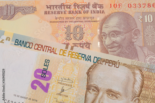 Wallpaper Mural A macro image of a orange ten rupee bill from India paired up with a beige, twenty sol bill from Peru.  Shot close up in macro. Torontodigital.ca