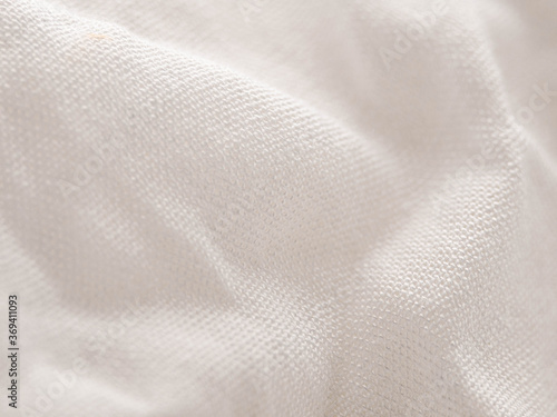 Texture of white fabric shows a soft, comfortable feel. Abstract background.