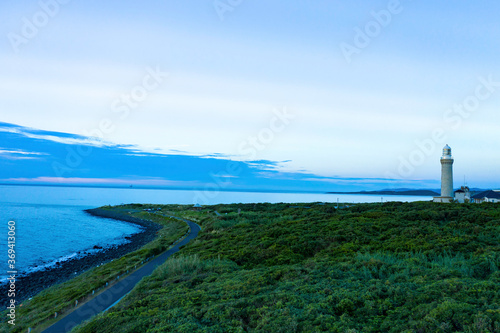 角島の岬の上空から夕刻の海を背景に灯台がある風景が美しい