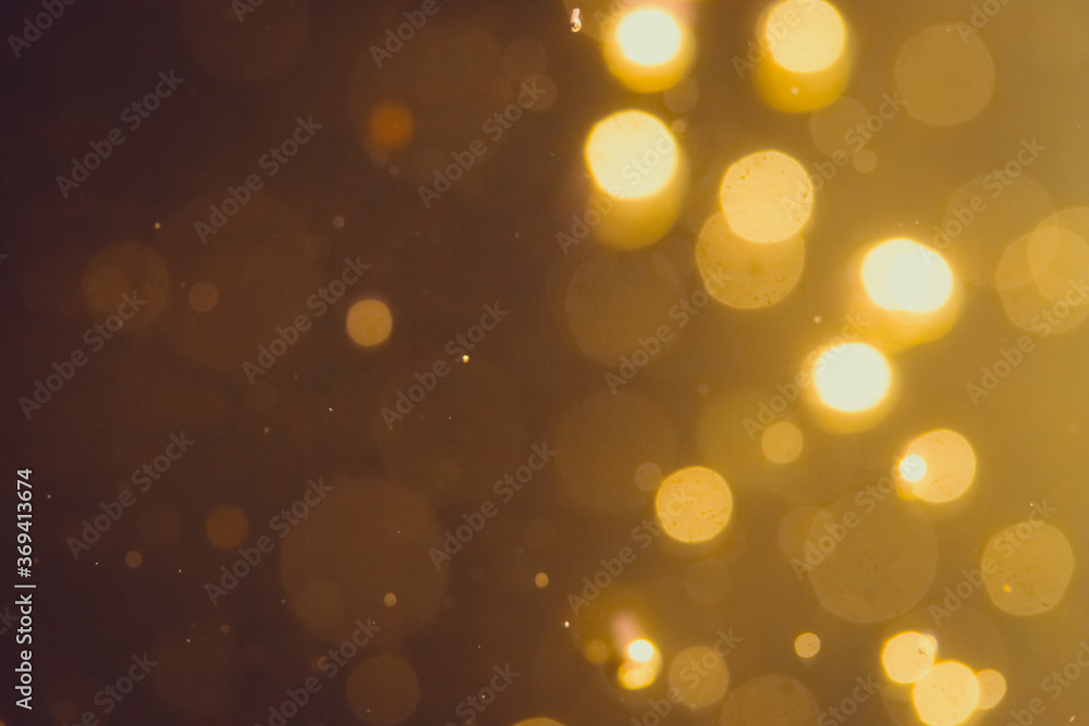 Fototapeta premium Dark Abstract Gold bokeh sparkle on black background