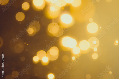 Dark Abstract Gold bokeh sparkle on black background