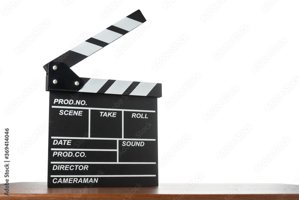 Movie clapperboard on table on white isolated background