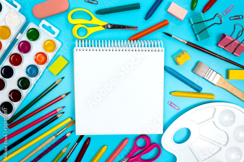 Kids art tools. Sketchbook notepad open blank page mockup top view. Empty white sheet copy space. DIY craft equipment. Drawing and painting supplies for children. Back to art school concept flatly.