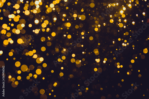 Abstract gold defocused bokeh of lights in dark
