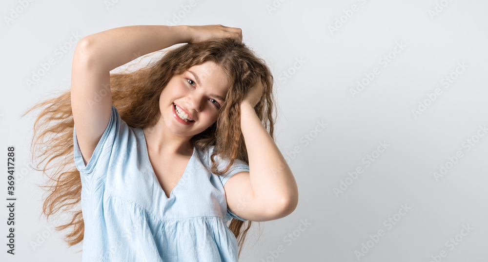 Portrait of attractive carefree european girl, tilting head up and shaking curly hair. Living life to fullest. Having fun and being amused. Copy space for your text Portrait of attractive carefree european girl, tilting head up and shaking curly hair. Living life to fullest. Having fun and being amused. Copy space for your text