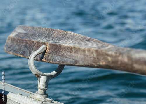 Wooden oar in a aluminum rowlock photo